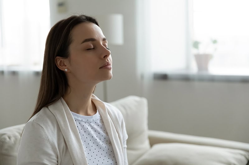 Woman enjoying clean air quality in her Ithaca, NY, home.